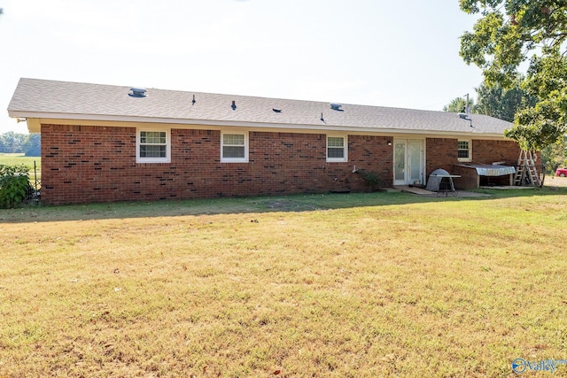 rear view of property with a yard