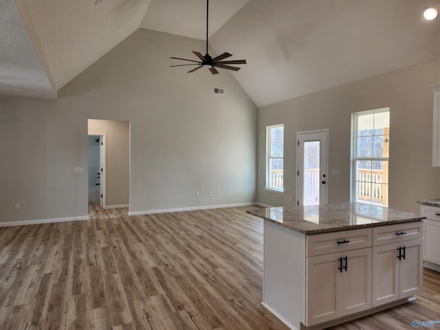 kitchen featuring open floor plan, visible vents, light wood-style flooring, and white cabinetry