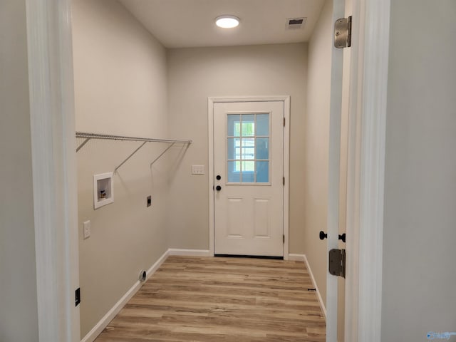 laundry area featuring hookup for a washing machine, laundry area, visible vents, baseboards, and light wood finished floors