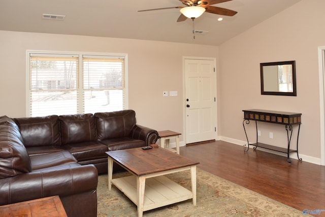 living area featuring vaulted ceiling, dark wood-style floors, visible vents, and ceiling fan