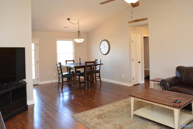 living room with a ceiling fan, lofted ceiling, dark wood-style floors, and baseboards