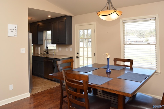 dining space with baseboards, lofted ceiling, and dark wood-style flooring