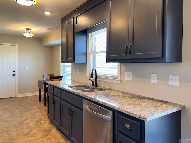 kitchen featuring light stone counters, baseboards, visible vents, a sink, and stainless steel dishwasher