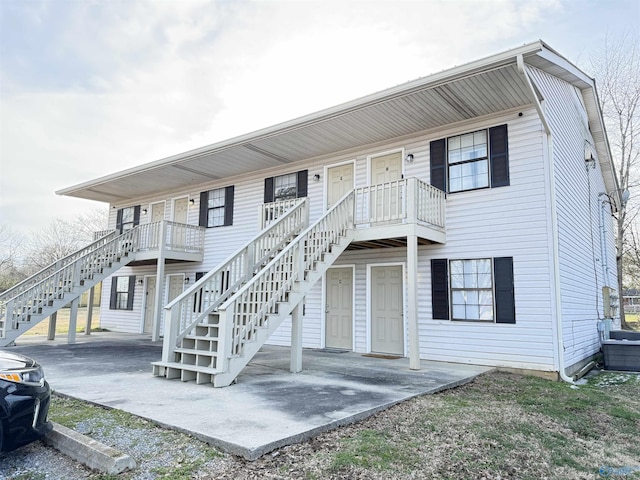 view of front facade featuring a patio area and stairway