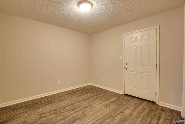 403 Rooks St, Hartselle, AL 35640 - empty room with a textured ceiling, dark wood finished floors, and baseboards