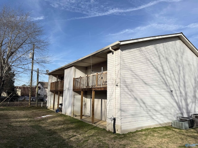 403 Rooks St, Hartselle, AL 35640 - view of property exterior featuring central AC unit, a lawn, and a balcony