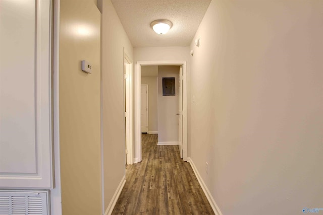 403 Rooks St, Hartselle, AL 35640 - hall featuring a textured ceiling, visible vents, baseboards, electric panel, and dark wood-style floors