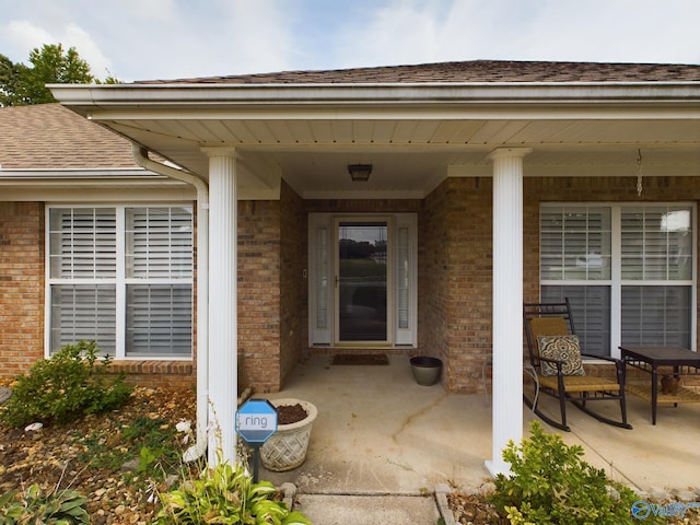 view of exterior entry with a porch