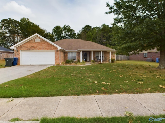 ranch-style house featuring a front yard, a garage, and central AC