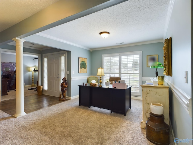 home office featuring a textured ceiling, decorative columns, hardwood / wood-style flooring, and crown molding