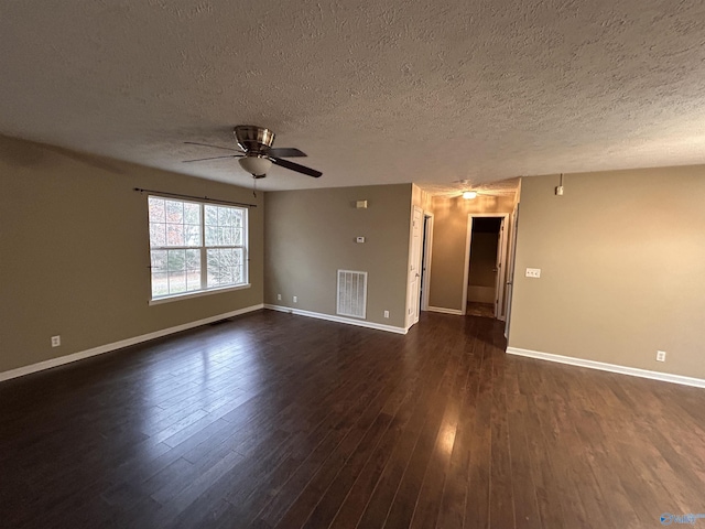 empty room featuring ceiling fan, dark hardwood / wood-style flooring, and a textured ceiling