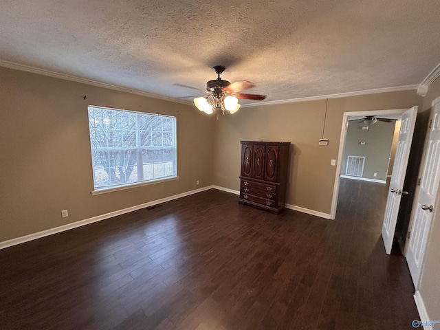 empty room with dark hardwood / wood-style flooring, a textured ceiling, ceiling fan, and ornamental molding