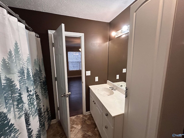 bathroom with a textured ceiling and vanity