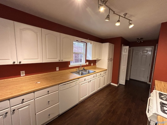 kitchen with dishwasher, range, white cabinetry, and sink