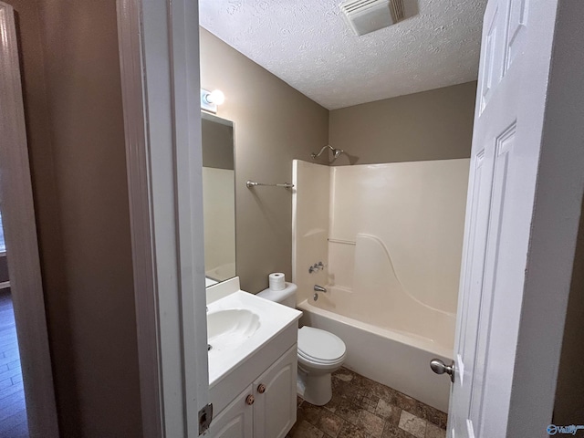 full bathroom with vanity, a textured ceiling, toilet, and shower / bathtub combination