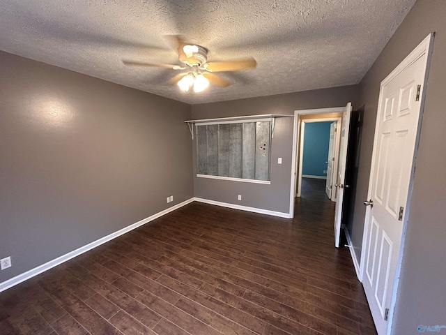 unfurnished bedroom with a textured ceiling, dark hardwood / wood-style flooring, and ceiling fan