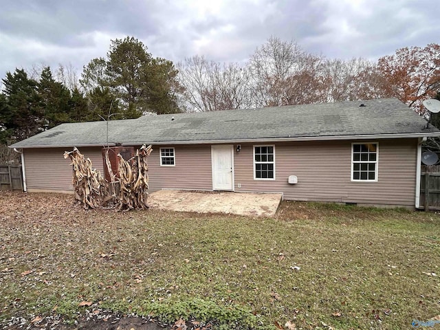 rear view of house with a lawn