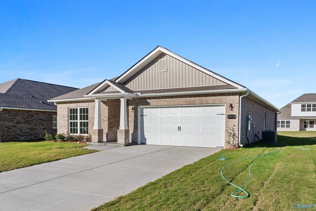 craftsman house with cooling unit and a garage