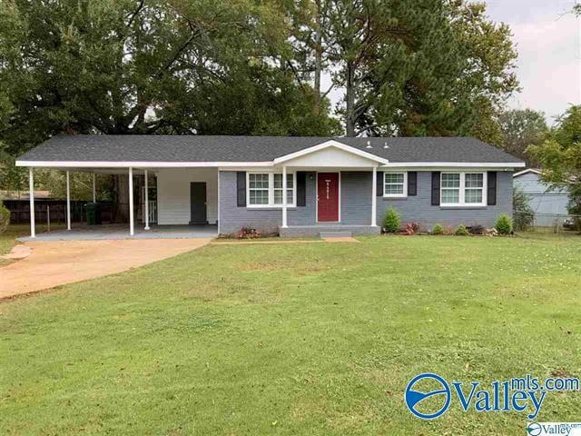 ranch-style home with a front yard and a carport