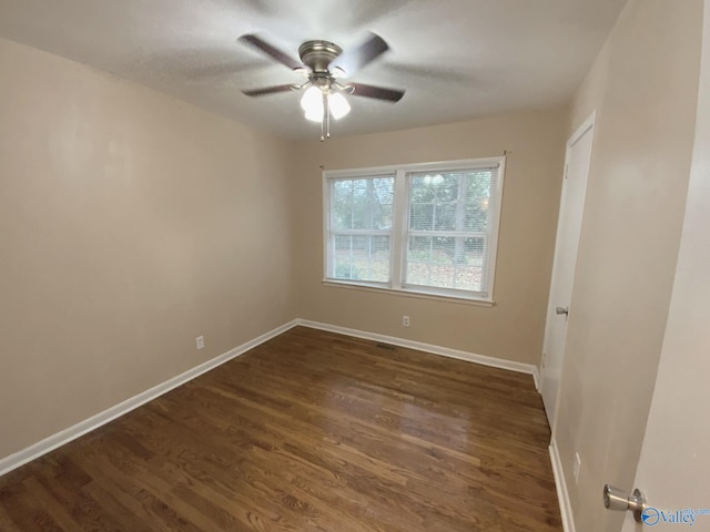 unfurnished room featuring ceiling fan and dark hardwood / wood-style flooring