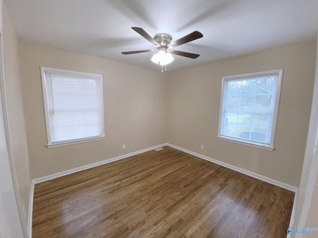 spare room featuring ceiling fan and dark hardwood / wood-style floors