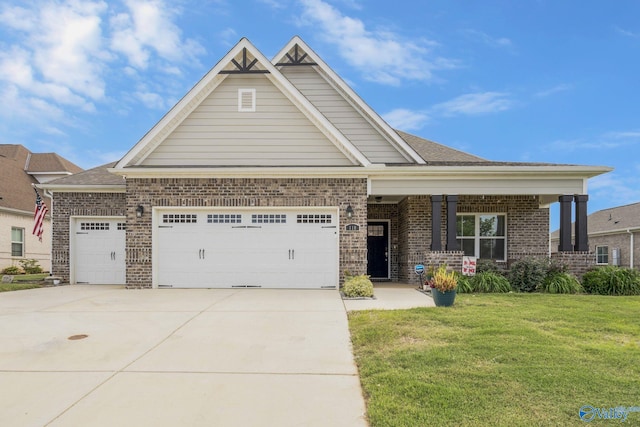 craftsman inspired home featuring a garage and a front lawn