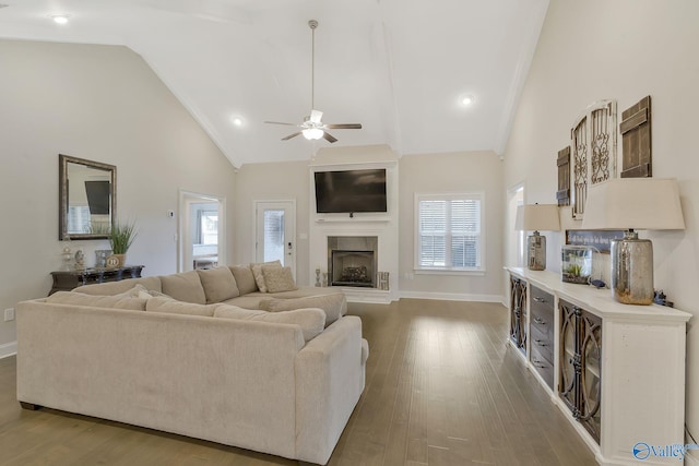 living room featuring high vaulted ceiling, ceiling fan, and wood-type flooring