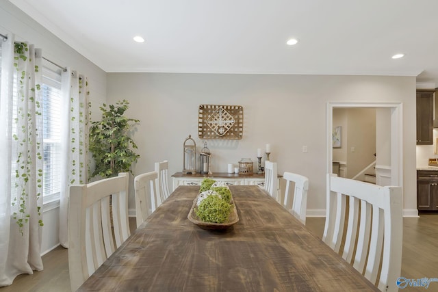 dining room with crown molding, plenty of natural light, and hardwood / wood-style flooring