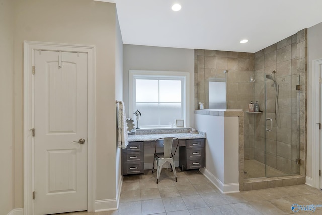 bathroom featuring vanity and a shower with door