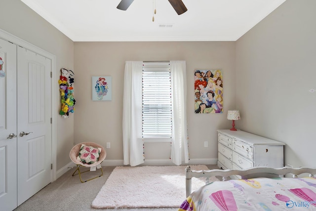 carpeted bedroom featuring ceiling fan and a closet