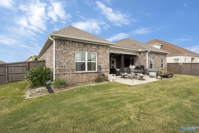 back of house with a yard and a patio