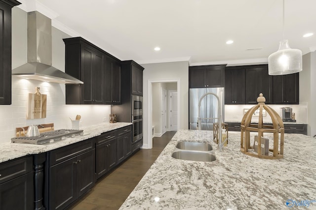 kitchen featuring ornamental molding, decorative light fixtures, wall chimney range hood, and dark hardwood / wood-style flooring