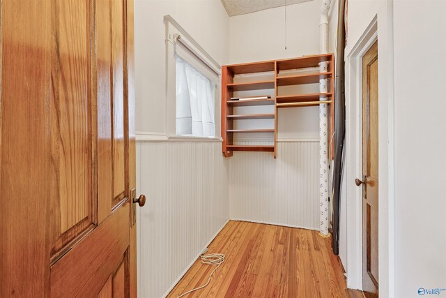 spacious closet with light hardwood / wood-style floors