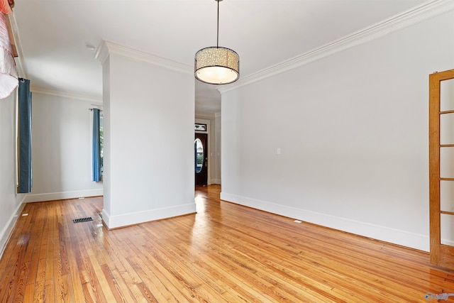 unfurnished room with light hardwood / wood-style floors and crown molding