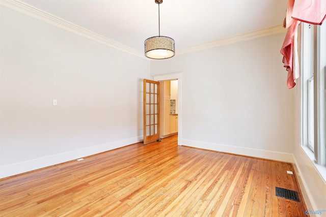 unfurnished room featuring light hardwood / wood-style floors and ornamental molding