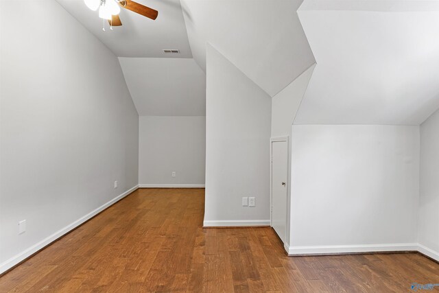 additional living space with wood-type flooring, lofted ceiling, and ceiling fan