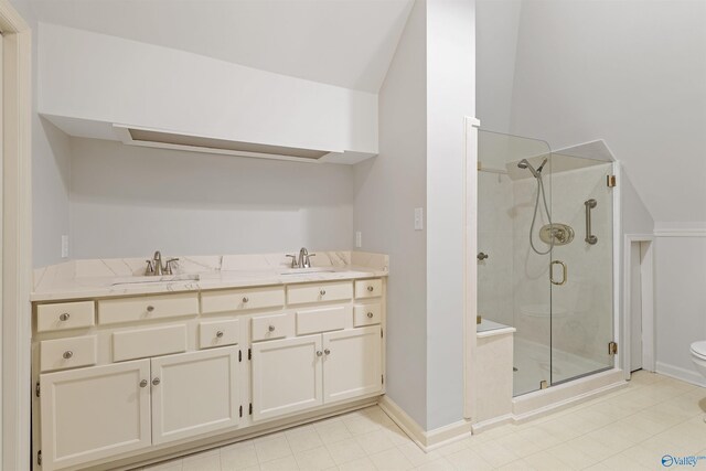 bathroom featuring toilet, double sink vanity, tile patterned flooring, and walk in shower