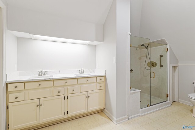 bathroom featuring double vanity, an enclosed shower, lofted ceiling, tile patterned floors, and toilet