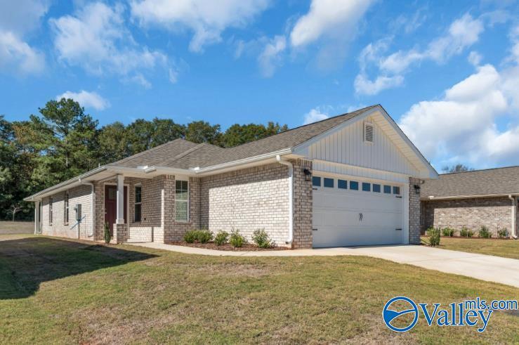 single story home with a front lawn and a garage