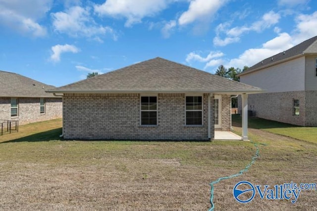 rear view of property featuring a yard