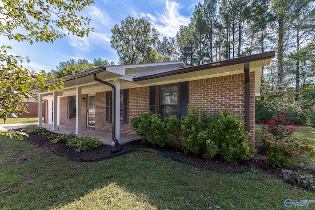 ranch-style home with a front yard and a porch