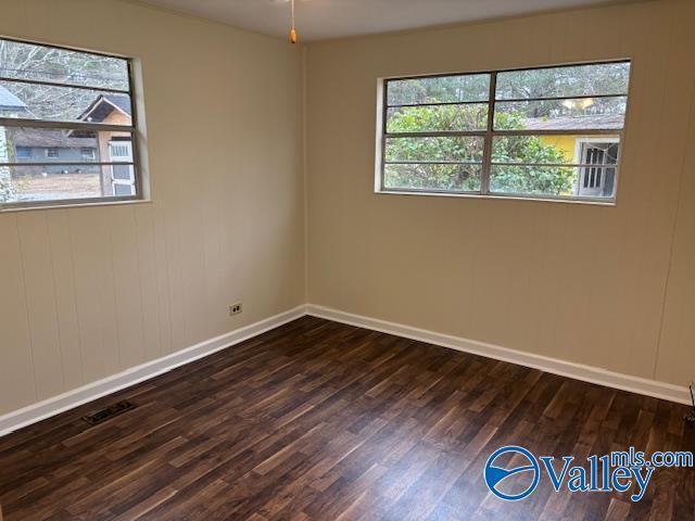 unfurnished room featuring dark hardwood / wood-style floors