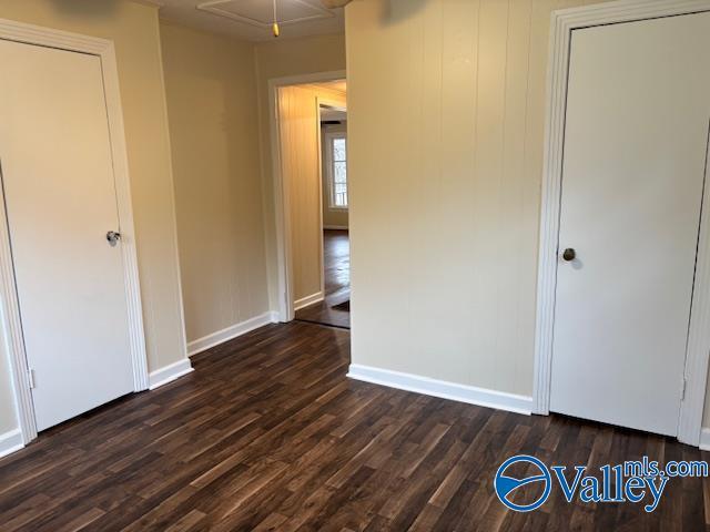 unfurnished bedroom featuring dark hardwood / wood-style floors