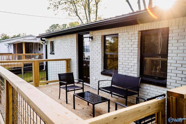 wooden terrace with outdoor lounge area