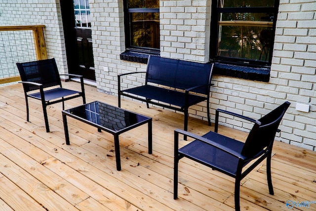 wooden terrace featuring an outdoor hangout area