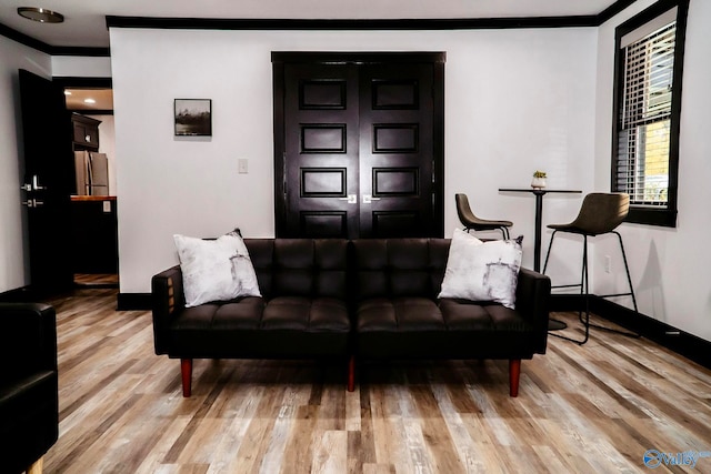 interior space featuring crown molding and light wood-type flooring