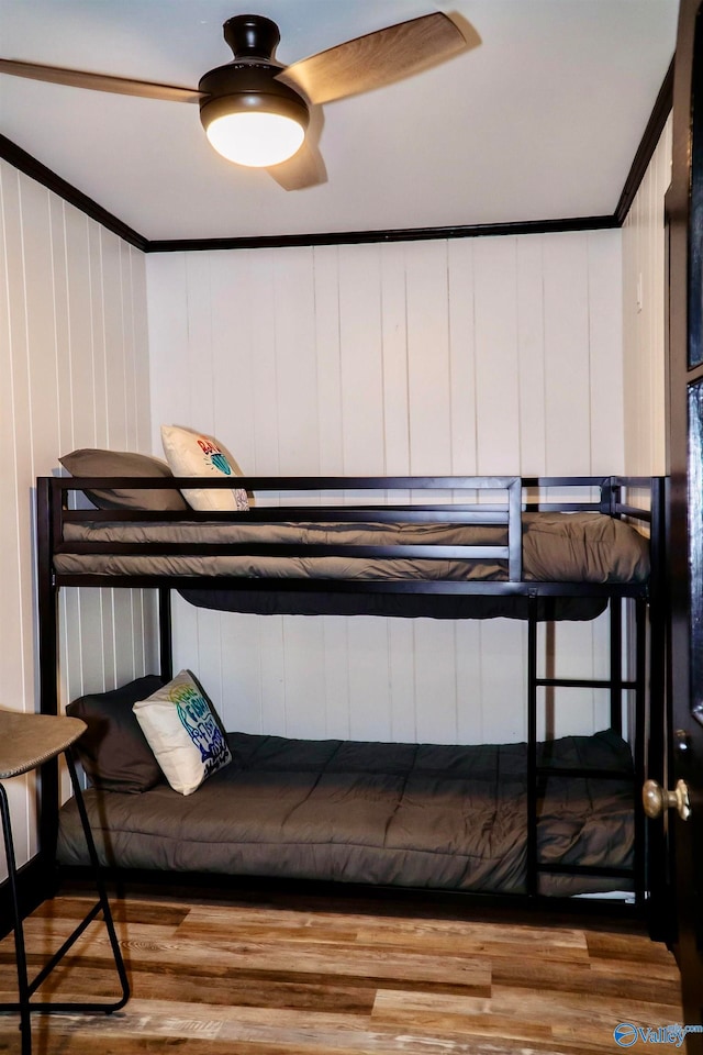 bedroom featuring ornamental molding, hardwood / wood-style flooring, and ceiling fan