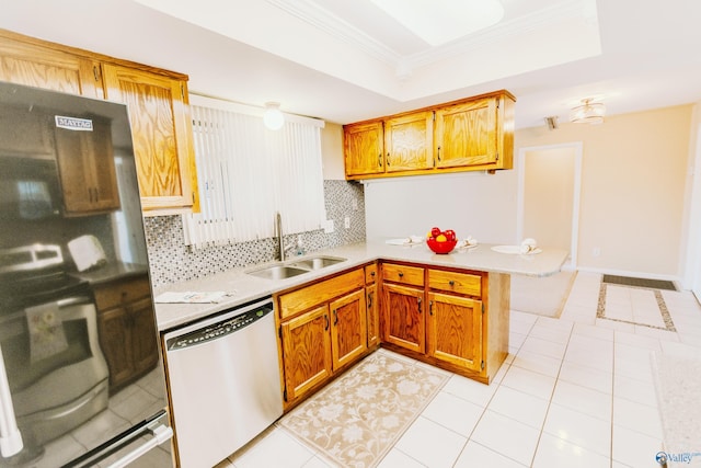 kitchen featuring decorative backsplash, a raised ceiling, a peninsula, light countertops, and stainless steel dishwasher