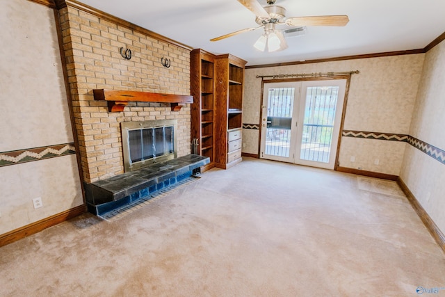 unfurnished living room featuring wallpapered walls, baseboards, crown molding, carpet floors, and a fireplace