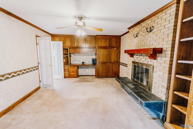 unfurnished living room featuring ceiling fan, ornamental molding, a brick fireplace, and baseboards